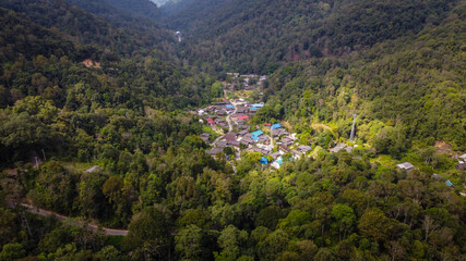 Fototapeta na wymiar Aerial view With a small village in the middle of the forest in the green countryside