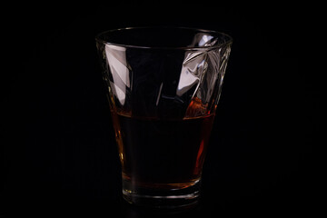 whiskey in a glass on a black background