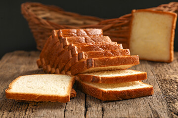 Bread slices on wooden background