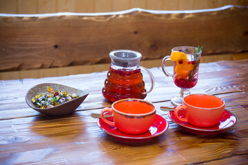 Tea cups and pot on wooden desk