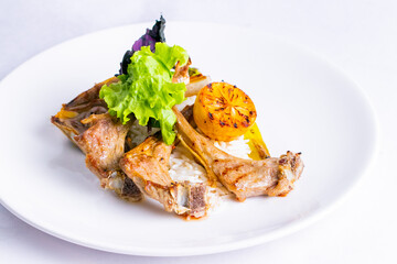 Delicious grilled entrecote with lemon isolated in white plate.