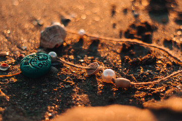 Moana's necklace of seashells in the sand