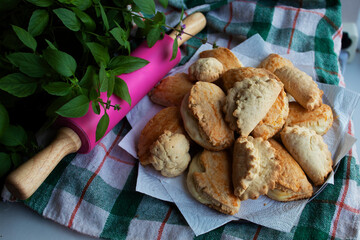 homemade cookies on the background of a checkered towel decorated with Basil leaves