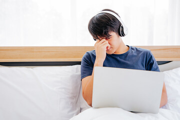 Serious man using Tablet  while sitting on sofa. COPY SPACE. Trading. WORK FROM HOME Concept.