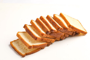 Cut of loaf bread on white against white background