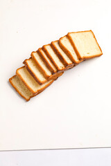 Cut of loaf bread on white against white background