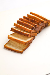 Cut of loaf bread on white against white background