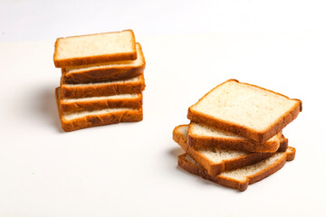Cut of loaf bread on white against white background