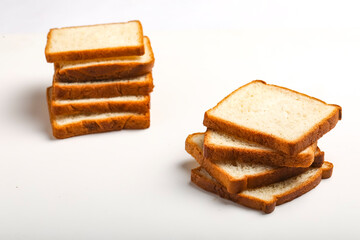 Cut of loaf bread on white against white background