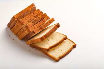 Cut of loaf bread on white against white background