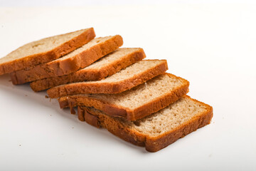 Cut of loaf bread on white against white background