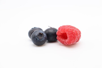 blueberries and raspberry on white background