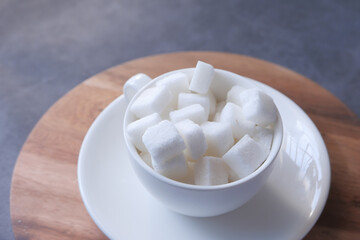 cup of tea and sugar cube on table