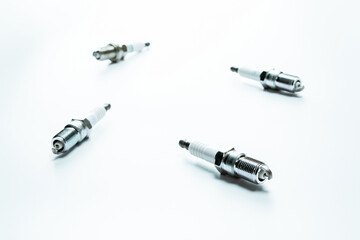 Auto mechanic. Set of new metal car part. Auto spark plugs or automotive piece isolated on white...