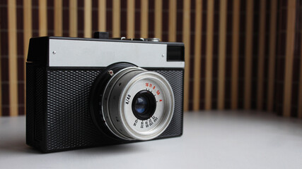 Old camera. Retro camera. Old photographic film rolls. Place for your text. Selective focus.