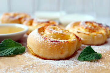Sweet puff pastry roll for breakfast or snack served with honey and milk. Top view with copy space. Healthy food.