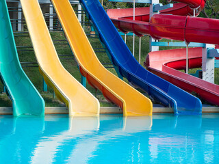 Colorful plastic water-slide in swimming pool or water park.