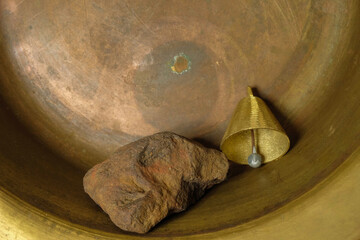 Ocher stone and gold bell on a copper surface. Metal and stone texture. Fortuna Gold Color. Copy...