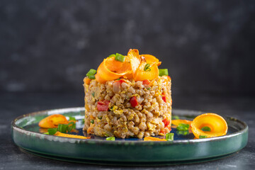 Boiled buckwheat with fried eggs, red peppers, carrots and onions