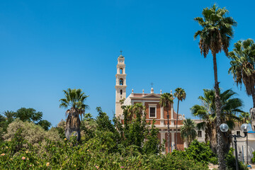 Fototapeta na wymiar Bell tower and facade of the Saint Peter Church, Franciscan church in Old Jaffa in Tel Aviv Yaffo, Israel, View from the top of the hill in Jaffa old city.
