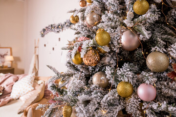Christmas toys on a fir-tree close up with interior background