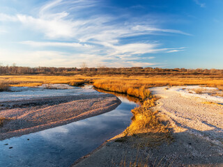 Beach marsh inlet during sunset in late autumn.