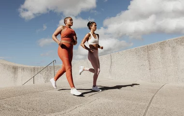 Zelfklevend Fotobehang Two women jogging together © Jacob Lund
