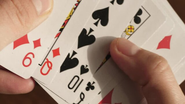 shuffling playing cards, playing cards in hands