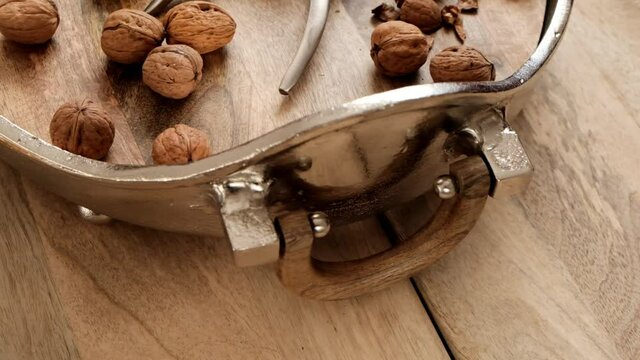 Walnuts and nutcracker in a round silver platter