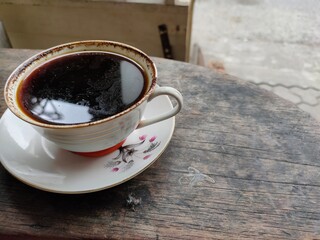 Black coffee on wood background