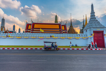 Bangkok, Thailand - 20 Dec 2019: Traffic on the road in front of Wat Phra Kaew (Wat Phra Kaew) and the Grand Palace in Bangkok, Thailand on 20 Dec 2019: