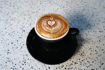 Close up mug cup of hot Latte art coffee on marble table