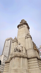 Fototapeta na wymiar The Cervantes monument in the Plaza de Espana (Spanish for 'Spain Square'), Madrid, Spain