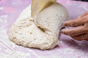 Close up of girl kneading dough