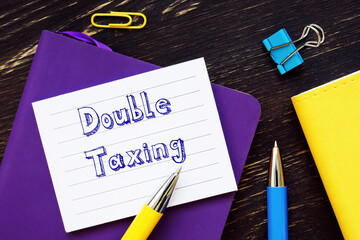 Financial concept meaning Double Taxing with sign on the sheet.
