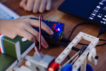 The boy is programming on a laptop. Scratch robot programming. Gigo robot programming
