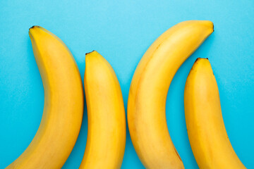 Four bananas as a symbol of male phalos. Big and small penis, sex education.
