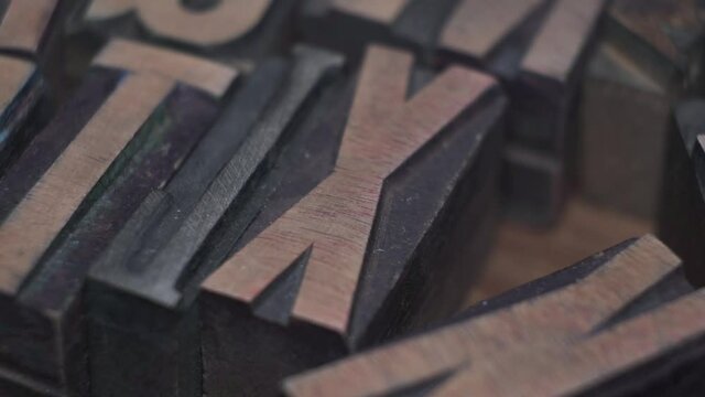 macro background of vintage wooden letterpress, diagonal right to left camera tracking 