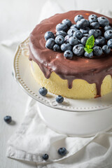 Closeup of blueberry cheesecake with chocolate glaze