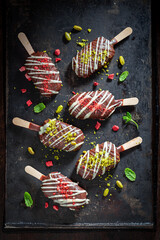 Delicious Popsicles with  pistachios and chocolate topping