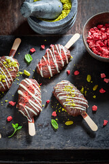 Homemade Popsicles with  pistachios and chocolate topping