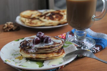 pancakes with honey cherry coffee and fork