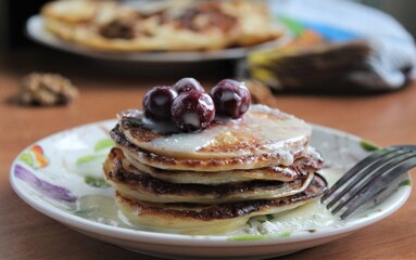 pancakes with cream and cherry berries