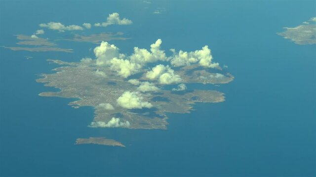 Flying over the Greek Islands. Airliner flies over Mikonos, Greek Islands, Aegean Sea.