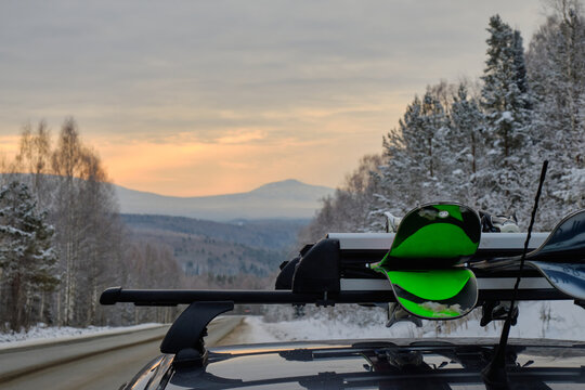 Roof Rack Of A Ski And Snowboard Car With A Mountain Background In Winter