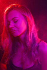 young woman under colored light