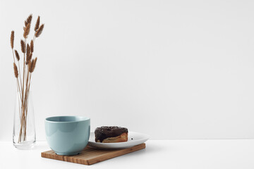 Mug and donuts cakes on a white background. Confectionery, coffee shop. Copy space, mock up.