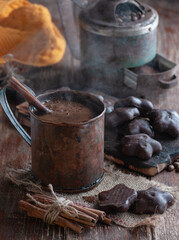 hot coffee in a copper mug with chocolate chip cookies and cinnamon