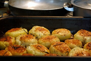 Baked potato on a pan with rosemary and garlic