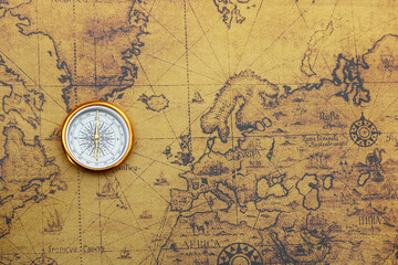 Classic round compass on old vintage map depicting North America and the United States of America as symbol of tourism with compass, travel with compass and outdoor activities with compass